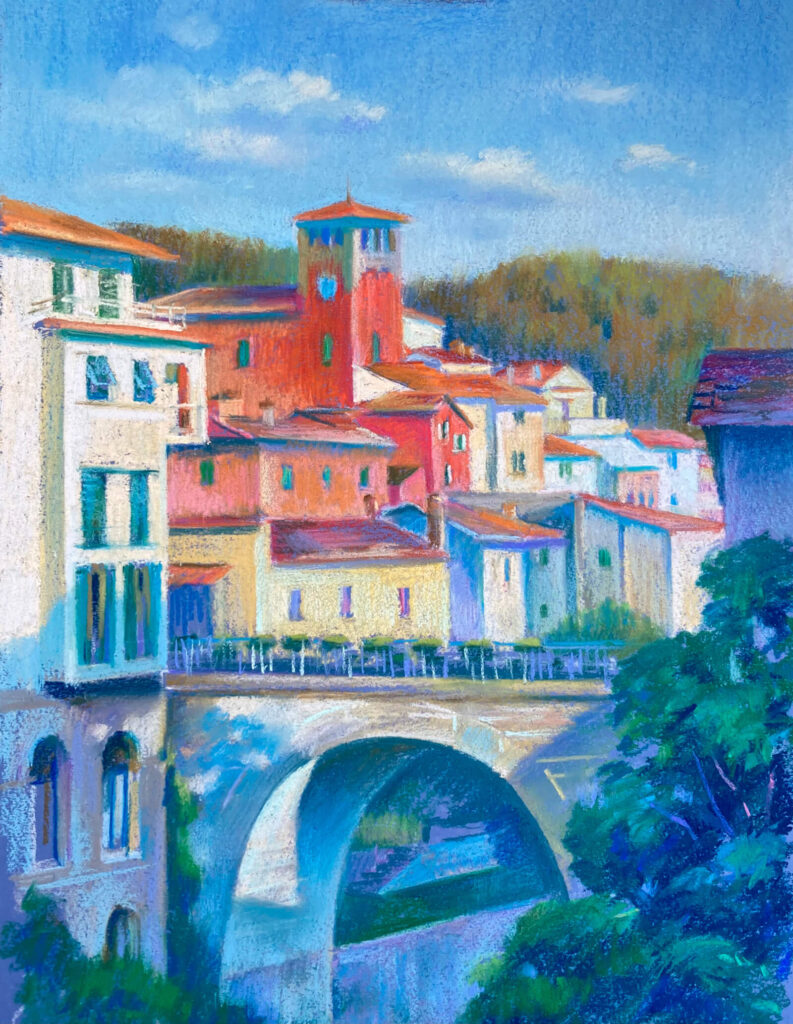 Scenery view with the red clock tower of Loro Ciuffenna with the bridge in foreground.