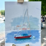 impression of a red sailing boat on the harbour in Lecco