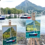 2 artist's easels with the sailing boat and the real boat on the background