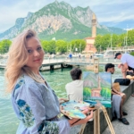 blonde lady smiling with her painting